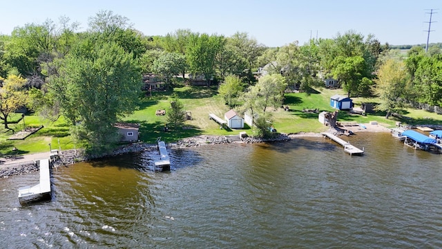 view of subject property featuring a nearby body of water and a tree filled landscape