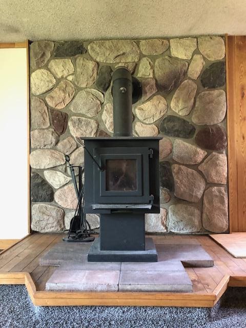 detailed view of a wood stove and a textured ceiling