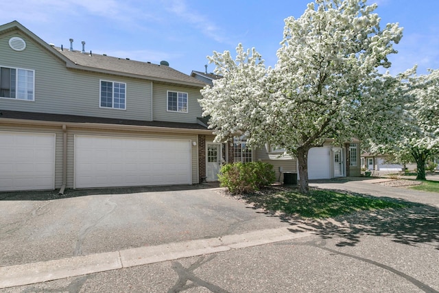 view of front of property with asphalt driveway and a garage
