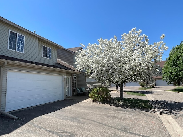 view of front of house featuring asphalt driveway
