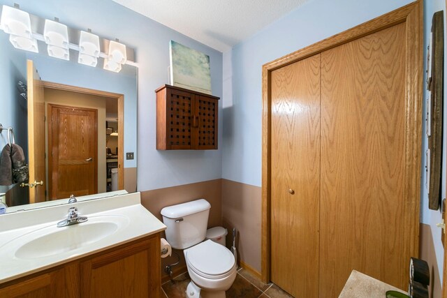 bathroom with toilet and vanity