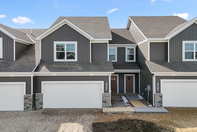 20104 78th Pl, Corcoran, MN 55340 - townhome / multi-family property with stone siding, an attached garage, board and batten siding, driveway, and a shingled roof