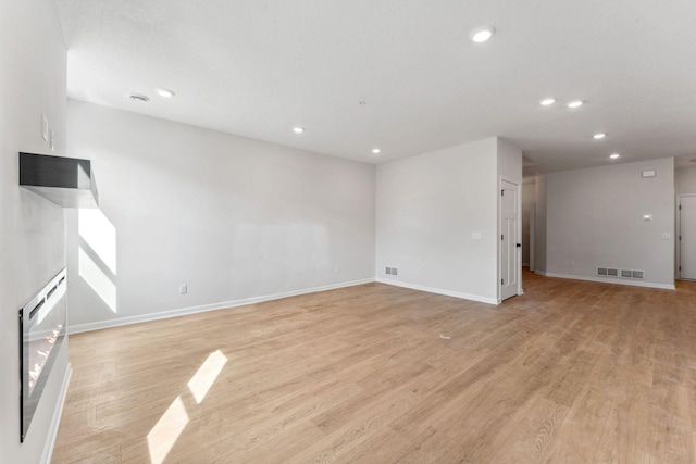 20104 78th Pl, Corcoran, MN 55340 - unfurnished living room with recessed lighting and light wood-style flooring