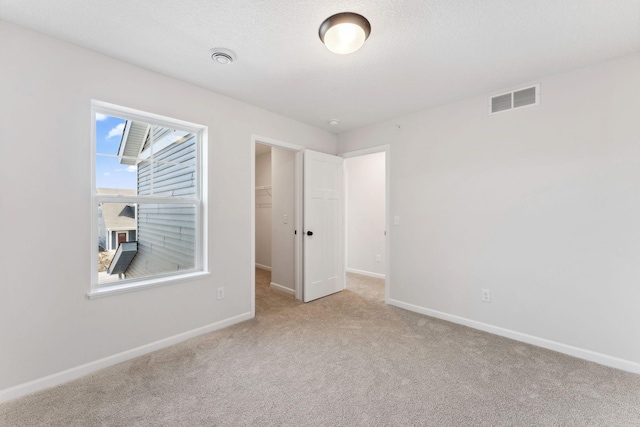 20104 78th Pl, Corcoran, MN 55340 - unfurnished bedroom with carpet flooring, a walk in closet, and a closet