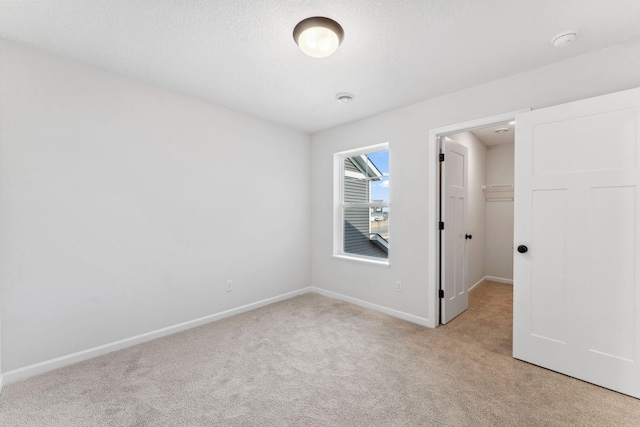20104 78th Pl, Corcoran, MN 55340 - unfurnished bedroom with light carpet, a walk in closet, and a closet