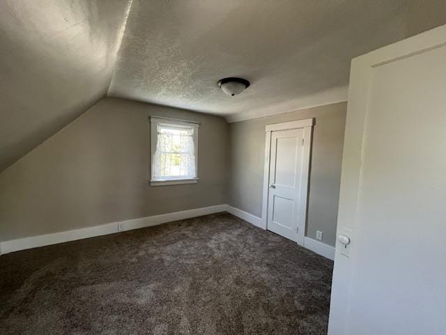 400 Main St W, Morristown, MN 55052 - bonus room featuring vaulted ceiling, carpet floors, baseboards, and a textured ceiling