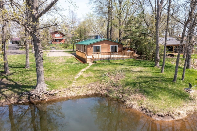 back of house with a deck, a yard, and log veneer siding