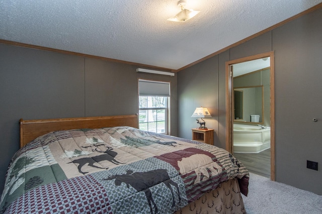 bedroom featuring crown molding, vaulted ceiling, a textured ceiling, carpet flooring, and connected bathroom