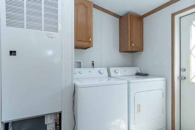 washroom with washer and dryer, a heating unit, cabinet space, and ornamental molding