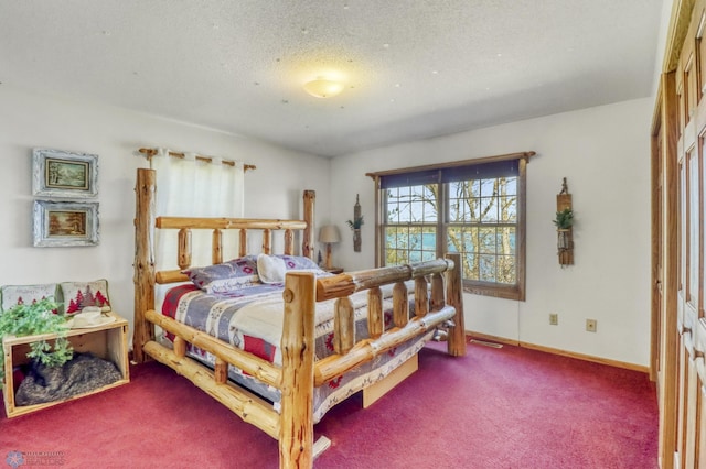 bedroom featuring carpet flooring, a textured ceiling, and baseboards