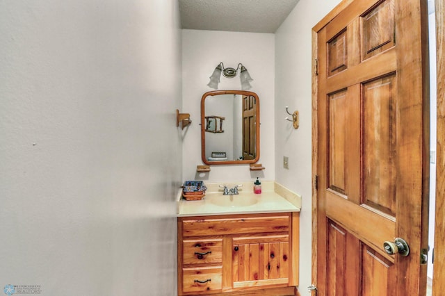 bathroom featuring vanity and a textured ceiling
