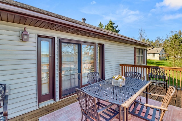 wooden terrace with outdoor dining space