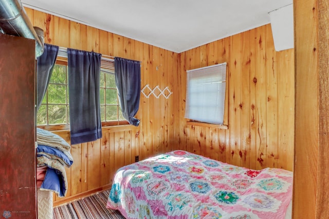 bedroom featuring wood walls