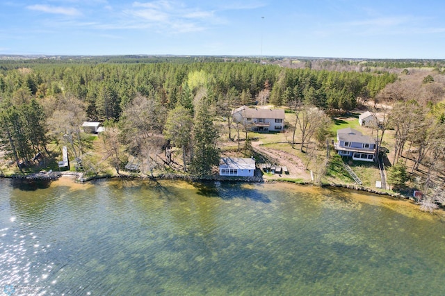 aerial view of a heavily wooded area and a nearby body of water
