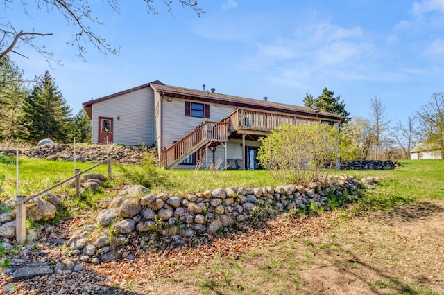 rear view of property with stairs, a deck, and a lawn