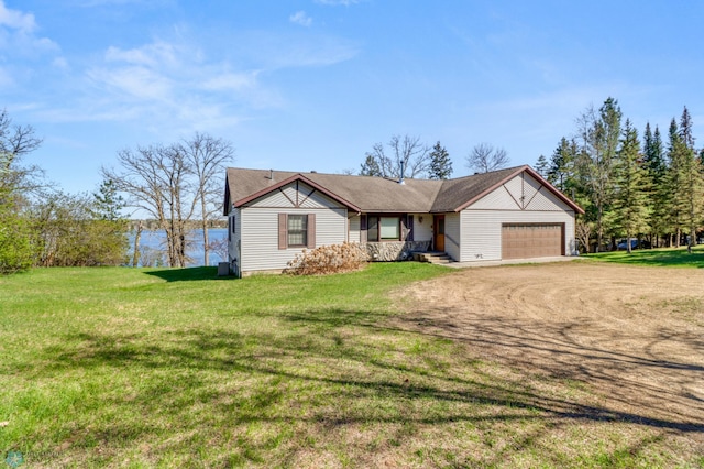 single story home featuring dirt driveway, an attached garage, and a front yard