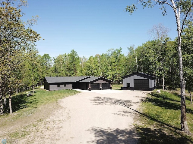 14840 Eaglewood Dr, Burlington Twp, MN 56501 - ranch-style home featuring a garage, an outbuilding, a front yard, and a forest view