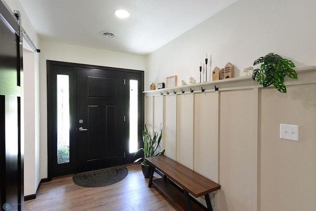 14840 Eaglewood Dr, Burlington Twp, MN 56501 - entryway featuring wood finished floors and a barn door