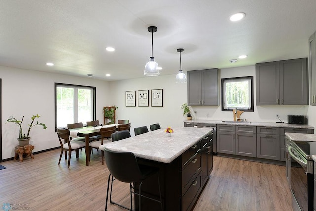 14840 Eaglewood Dr, Burlington Twp, MN 56501 - kitchen featuring a sink, a breakfast bar area, appliances with stainless steel finishes, a kitchen island, and recessed lighting