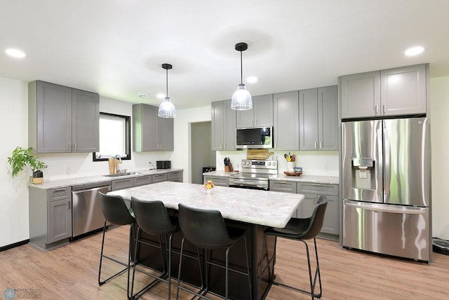 14840 Eaglewood Dr, Burlington Twp, MN 56501 - kitchen featuring stainless steel appliances, gray cabinetry, recessed lighting, a breakfast bar, and light wood-style flooring