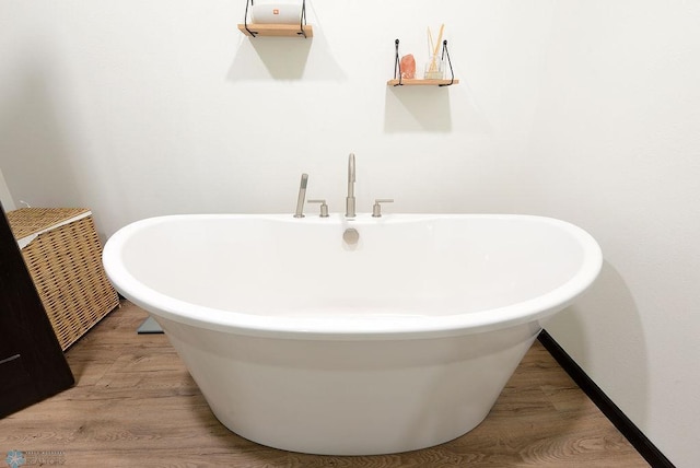 14840 Eaglewood Dr, Burlington Twp, MN 56501 - full bathroom featuring a freestanding tub and wood finished floors