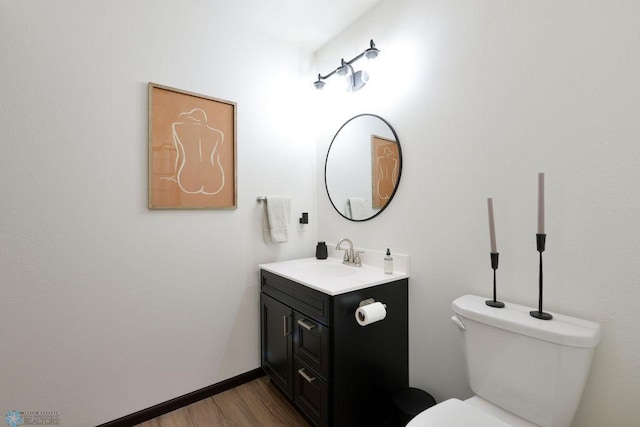 14840 Eaglewood Dr, Burlington Twp, MN 56501 - bathroom featuring wood finished floors, toilet, and vanity