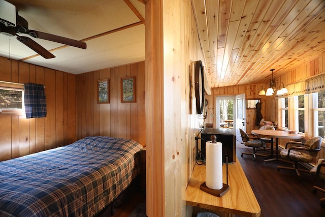 3291 Thomas Rd, Greenwood Twp, MN 55790 - bedroom featuring dark wood-style floors and wooden walls