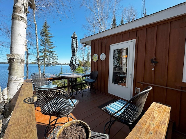 3291 Thomas Rd, Greenwood Twp, MN 55790 - wooden terrace featuring a water view and outdoor dining space