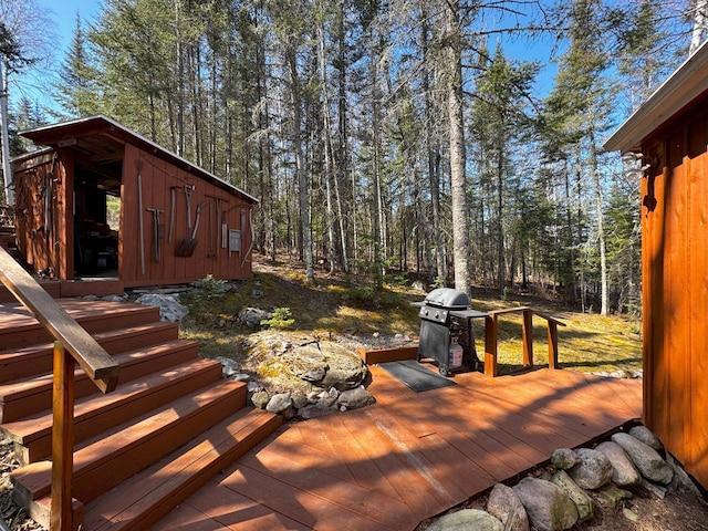 3291 Thomas Rd, Greenwood Twp, MN 55790 - deck with area for grilling and an outbuilding