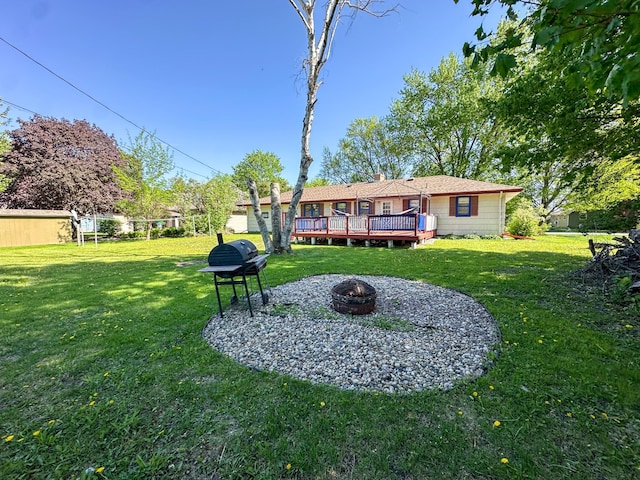 403 Dayton St, Arlington, MN 55307 - view of grassy yard with an outdoor fire pit and a wooden deck