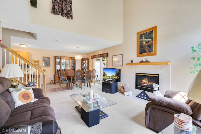 1785 Riverwood Dr, Burnsville, MN 55337 - living area featuring stairs, carpet, a fireplace, and a towering ceiling