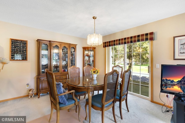 1785 Riverwood Dr, Burnsville, MN 55337 - dining room featuring a chandelier, light colored carpet, and baseboards