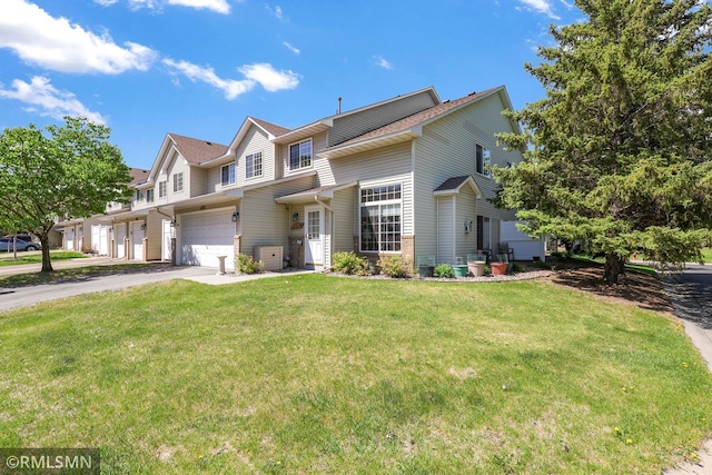 1785 Riverwood Dr, Burnsville, MN 55337 - view of front facade with a garage, driveway, and a front yard