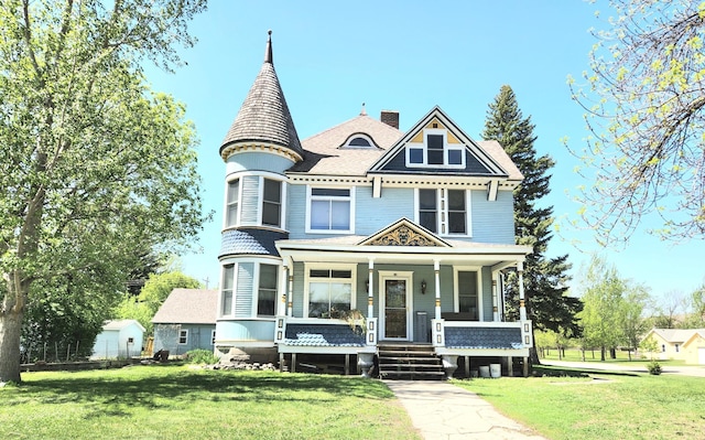 21 3rd St E, Ada, MN 56510 - victorian home featuring a porch, a front lawn, and a chimney