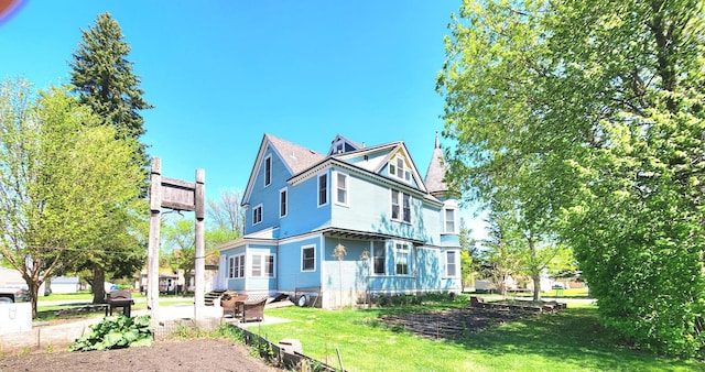 21 3rd St E, Ada, MN 56510 - rear view of property featuring a lawn and a patio