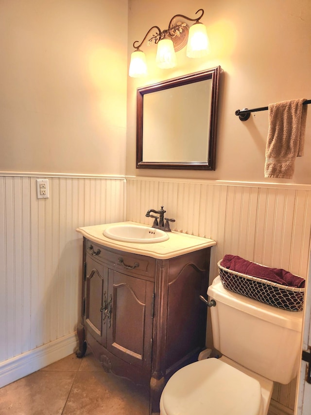 21 3rd St E, Ada, MN 56510 - half bath featuring toilet, a wainscoted wall, vanity, and tile patterned flooring