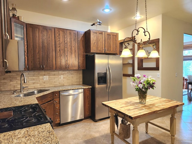 21 3rd St E, Ada, MN 56510 - kitchen featuring appliances with stainless steel finishes, a sink, tasteful backsplash, light tile patterned floors, and light stone counters