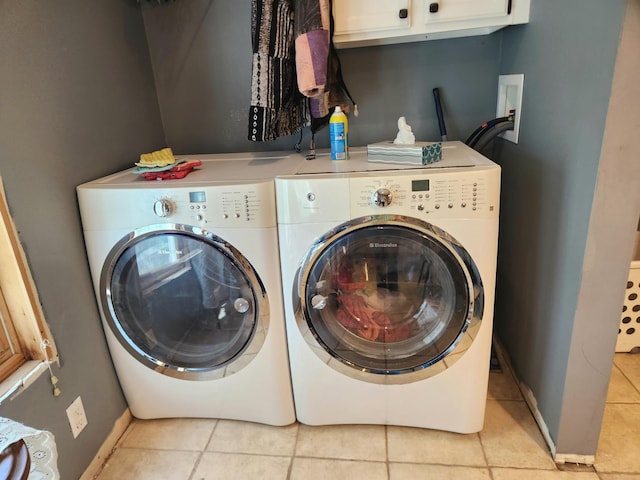 21 3rd St E, Ada, MN 56510 - washroom with washing machine and dryer, cabinet space, tile patterned flooring, and baseboards
