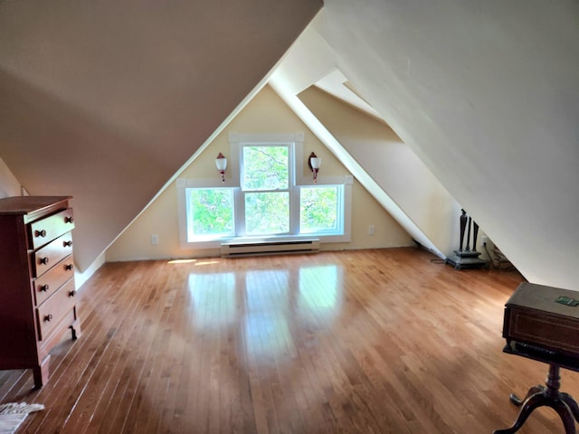 21 3rd St E, Ada, MN 56510 - additional living space featuring a baseboard radiator, hardwood / wood-style flooring, and vaulted ceiling