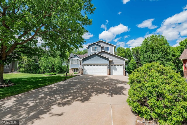 155 Palomino Ln, Lino Lakes, MN 55014 - view of front of home with concrete driveway, a front yard, and an attached garage