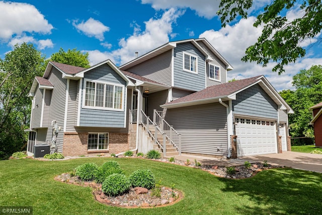155 Palomino Ln, Lino Lakes, MN 55014 - split level home featuring concrete driveway, a garage, a front yard, brick siding, and a shingled roof