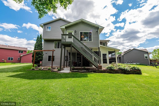 155 Palomino Ln, Lino Lakes, MN 55014 - back of house with a lawn, stairs, and a sunroom
