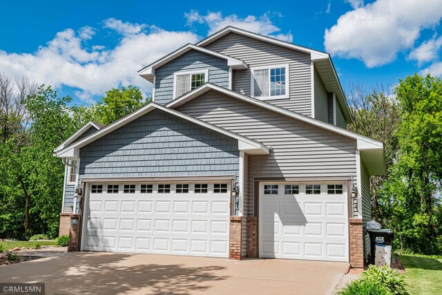 155 Palomino Ln, Lino Lakes, MN 55014 - view of front of house featuring concrete driveway, an attached garage, and brick siding