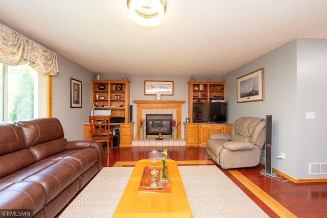155 Palomino Ln, Lino Lakes, MN 55014 - living area with wood finished floors, a tile fireplace, and baseboards