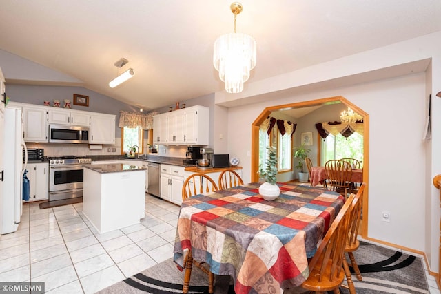 155 Palomino Ln, Lino Lakes, MN 55014 - dining space with a chandelier, lofted ceiling, and light tile patterned flooring