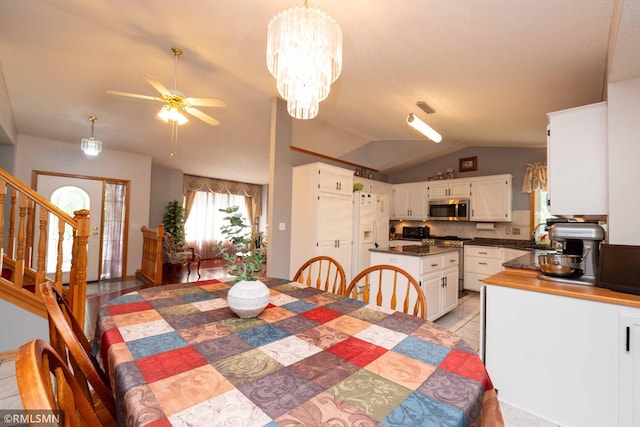 155 Palomino Ln, Lino Lakes, MN 55014 - dining space featuring lofted ceiling, stairs, ceiling fan, and a chandelier