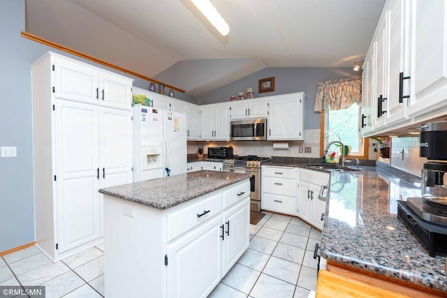 155 Palomino Ln, Lino Lakes, MN 55014 - kitchen with appliances with stainless steel finishes, a sink, dark stone countertops, vaulted ceiling, and a center island