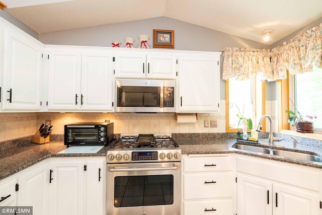 155 Palomino Ln, Lino Lakes, MN 55014 - kitchen featuring stainless steel appliances, a sink, vaulted ceiling, white cabinetry, and decorative backsplash