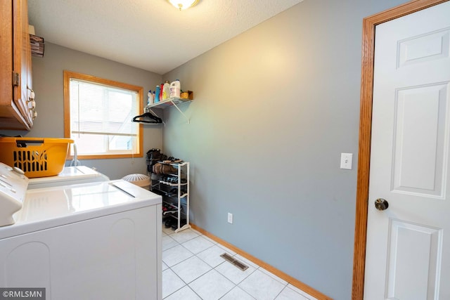 155 Palomino Ln, Lino Lakes, MN 55014 - laundry area featuring cabinet space, separate washer and dryer, baseboards, and light tile patterned flooring