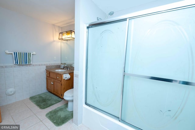 155 Palomino Ln, Lino Lakes, MN 55014 - full bathroom featuring tile walls, vanity, toilet, bath / shower combo with glass door, and tile patterned floors